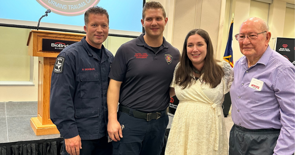Jennifer, a Heroes in Arms blood recipient, stands with her donor and the EMS crew who saved her life.