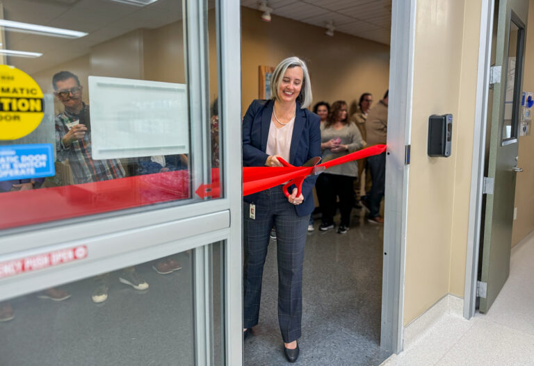 Mari Salmi cuts the ribbon to BioBridge Global's first stand-alone Cell Therapy Testing Laboratory.