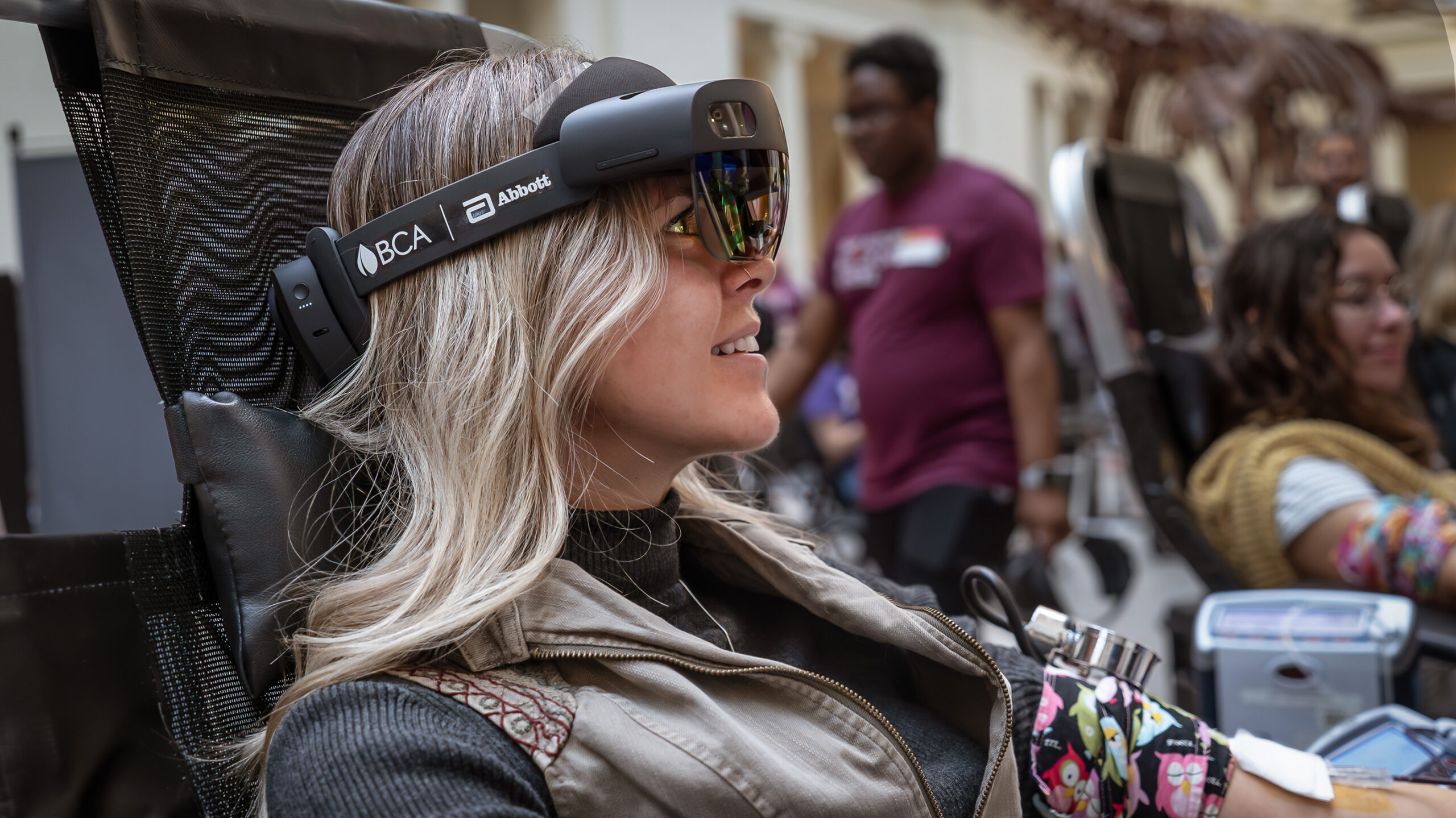 A donor uses a mixed-reality headset during her blood donation.