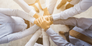 Image of team hand gesture to encourage joining a BioBridge Global Committee