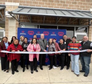 Community leaders pose in front of the Southeast Donor Center before its ribbon cutting