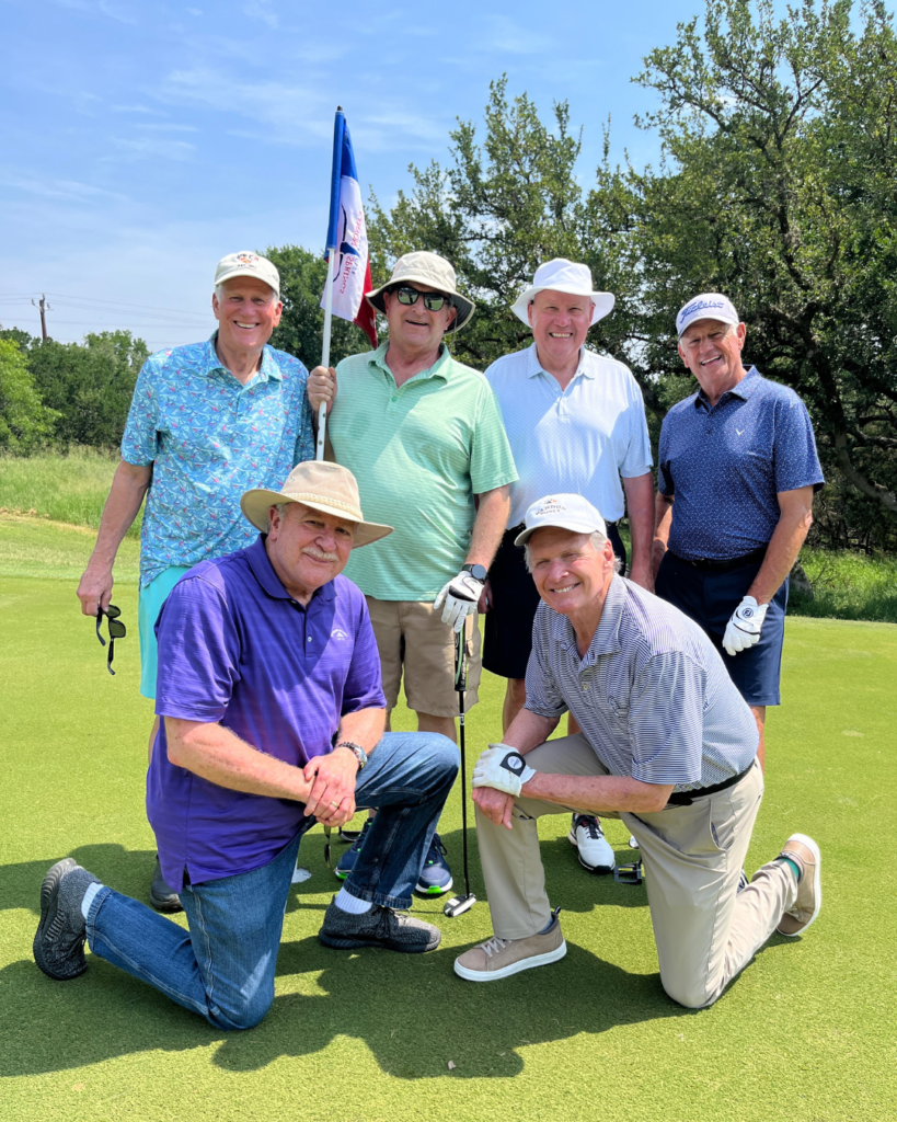 Golfers take a team photo on the green at the Driving fore Donors Golf Tournament