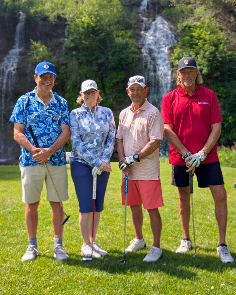 Golfers take a team photo on the green at the Driving fore Donors Golf Tournament.