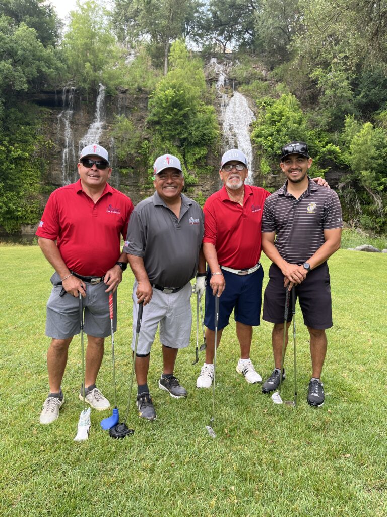 Golfers take a team photo on the green at the Driving fore Donors Golf Tournament