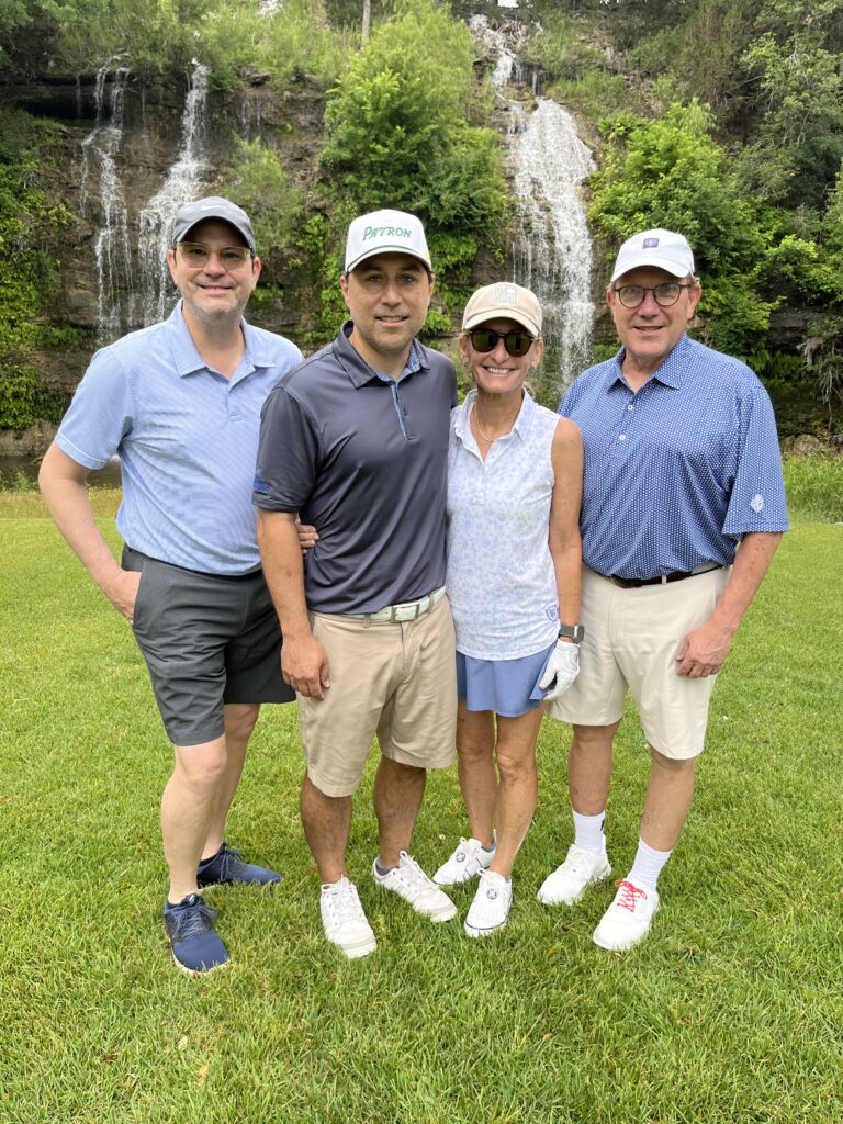 Golfers take a team photo on the green at the Driving fore Donors Golf Tournament
