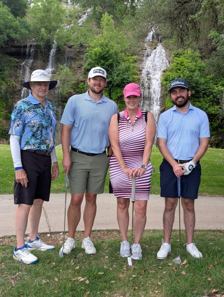 Golfers take a team photo on the green at the Driving fore Donors Golf Tournament