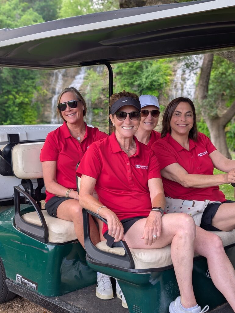 Golfers take a team photo on the green at the Driving fore Donors Golf Tournament