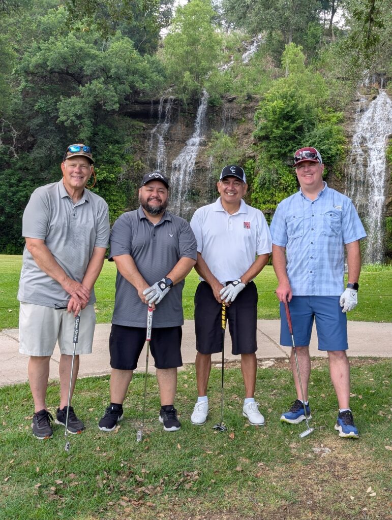 Golfers take a team photo on the green at the Driving fore Donors Golf Tournament