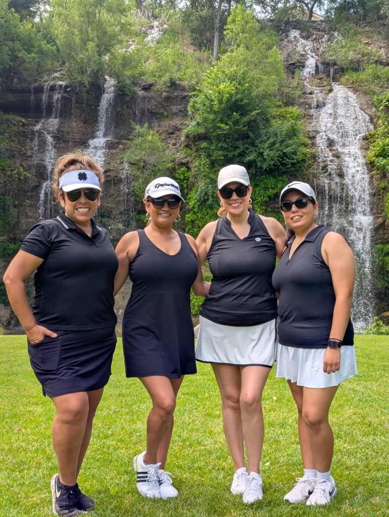 Golfers take a team photo on the green at the Driving fore Donors Golf Tournament