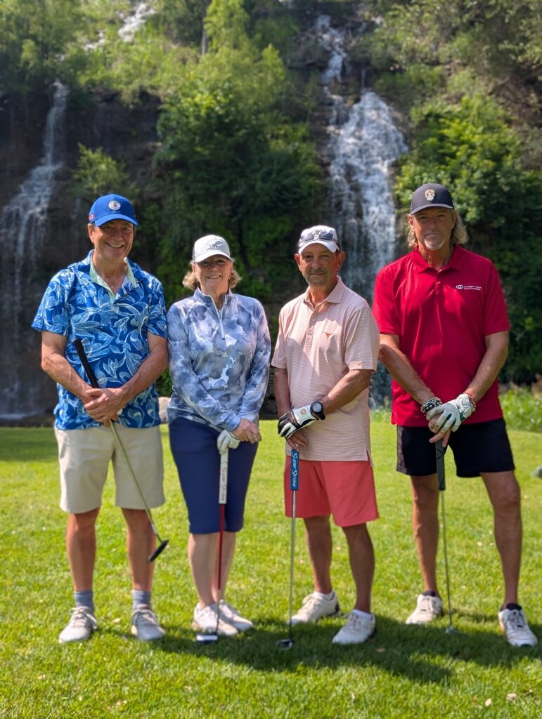 Golfers take a team photo on the green at the Driving fore Donors Golf Tournament