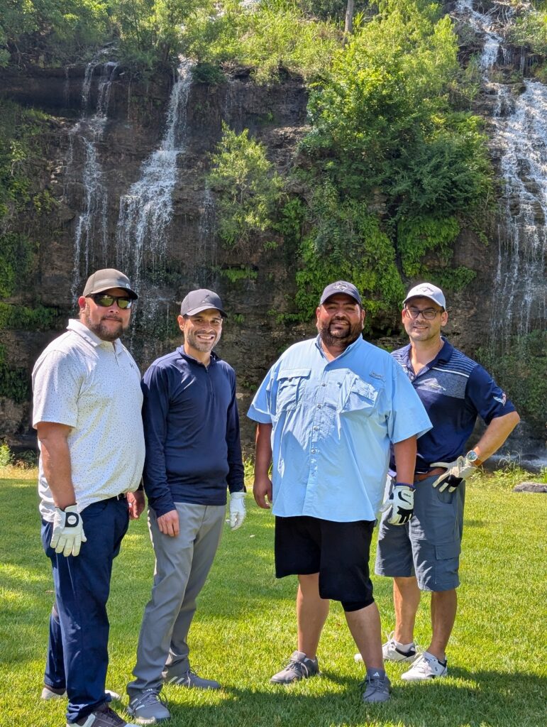 Golfers take a team photo on the green at the Driving fore Donors Golf Tournament