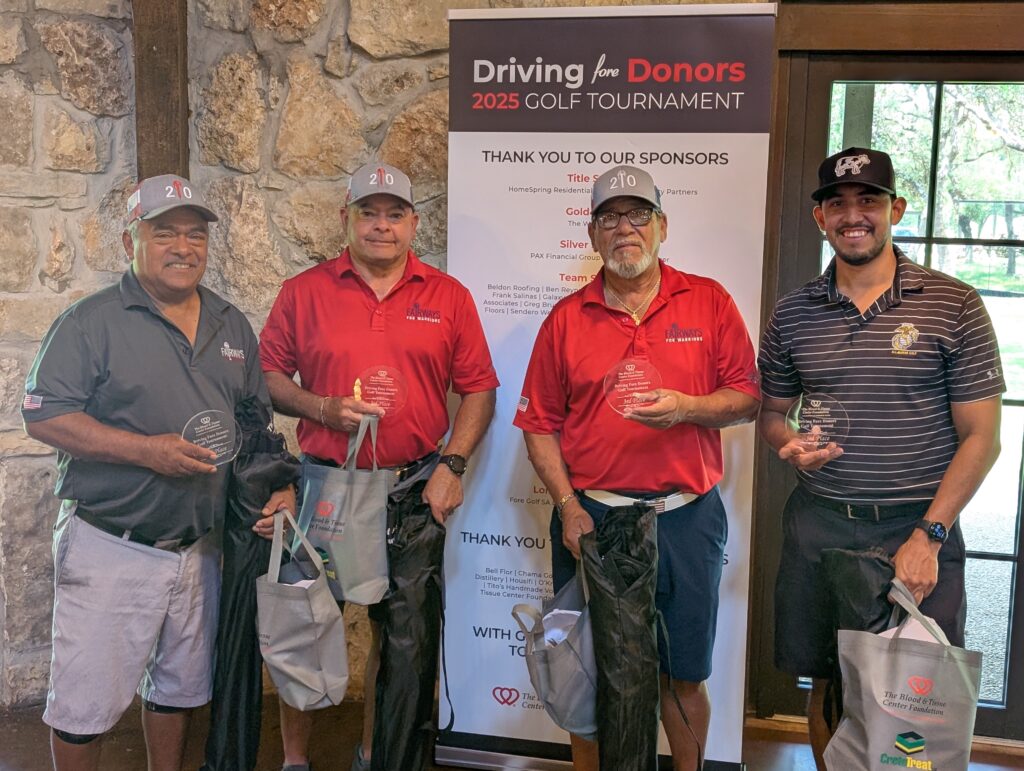 Golfers take a team photo on the green at the Driving fore Donors Golf Tournament