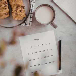 Monthly calendar with pastry and cup of milk