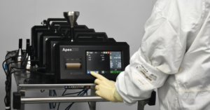 Technician operating Apex Z50 laboratory instrument touchscreen