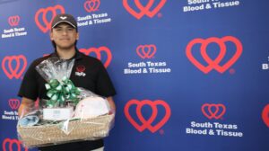 Person holding gift basket at blood donation event