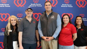 Five people posing at blood donation event