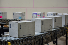 White boxes on warehouse conveyor system